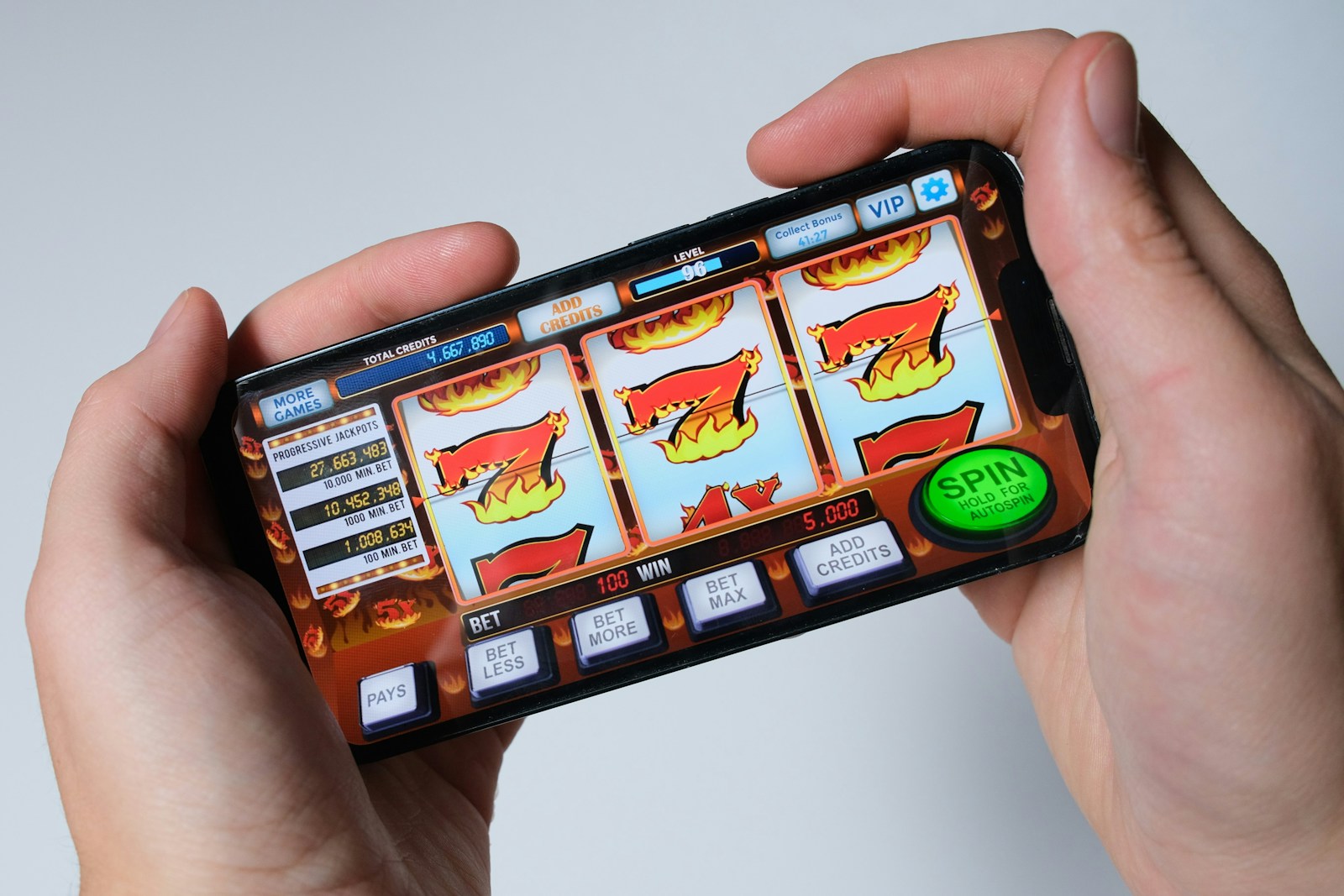 A person using a mobile slot game on a phone